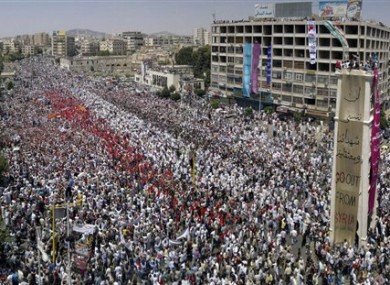 A citizen journalism image made on a mobile phone shows anti-regime protesters gathered in the western city of Hama, Syria, 22 July 2011.