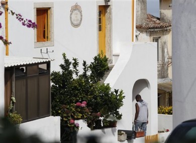 An unidentified man enters the house where neighbors said fugitive George Wright lived in Almocagema, near Lisbon Wednesday, Sept. 28, 2011.