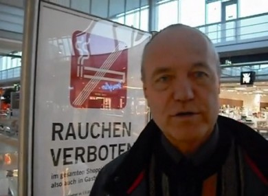 Dietmar Erlacher reporting from a large shopping centre where he films smoker flouting a smoking ban.