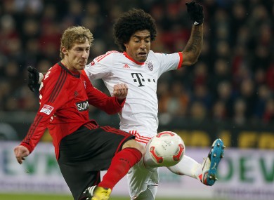 Leverkusen's Stefan Kiessling and and Bayern's Dante last season.