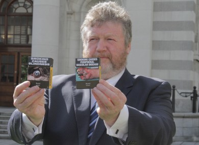 Health Minister James Reilly with a sample of the packaging (File photo)