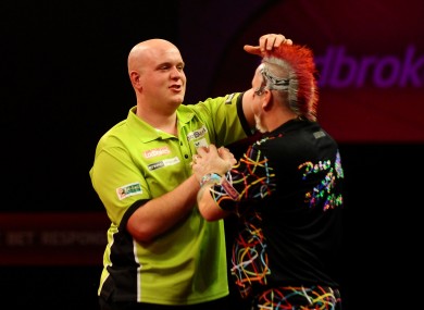 Michael Van Gerwen consoles Peter Wright after winning the Final of The Ladbrokes World Darts Championship at Alexandra Palace, London.
