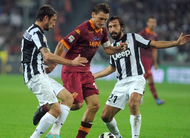Francesco Totti is challenged by Claudio Marchisio and Andrea Pirlo last season.